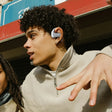 White wireless earbud worn in an ear.