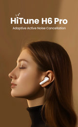 White wireless earbud worn in a person’s ear.