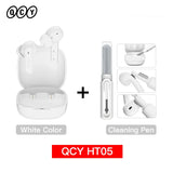 White wireless earbuds with cleaning pen.