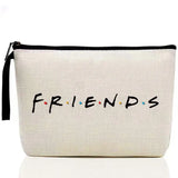 a white zipper bag with the word friends written on it