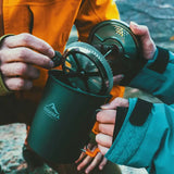 a man holding a cup with a compass