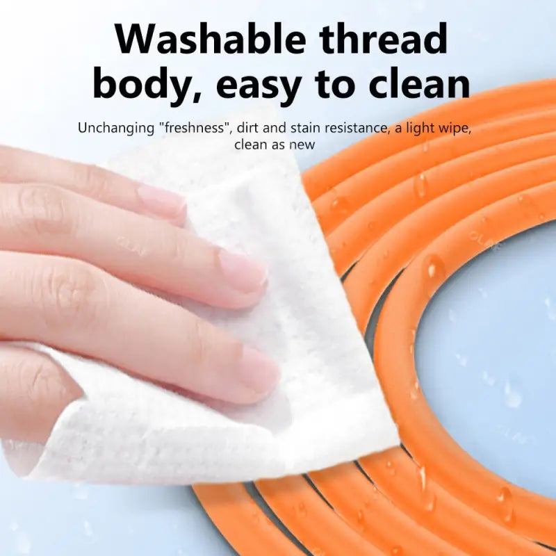 a hand is cleaning a hose with a cloth