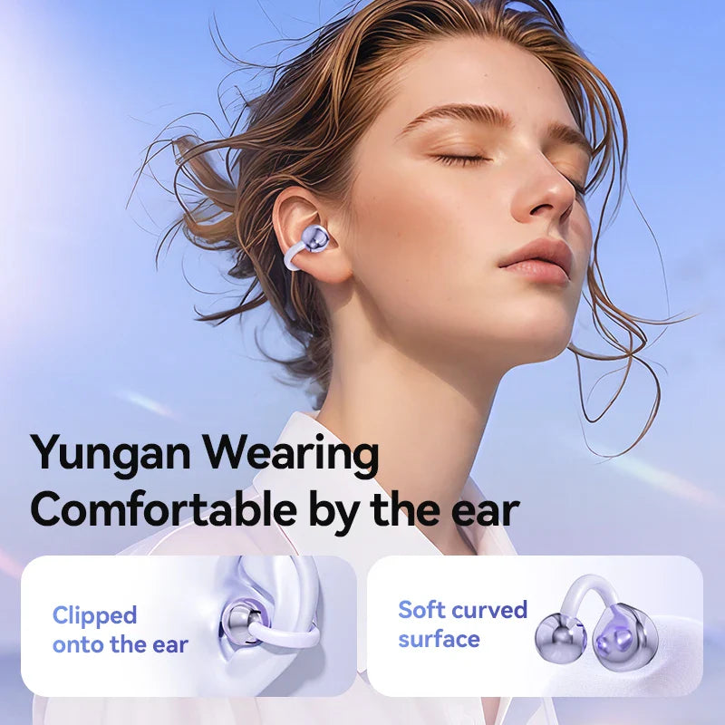 Wireless earbud with a soft curved surface design, clipped onto the ear.