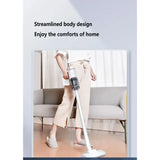 a woman standing on a white floor with a vacuum