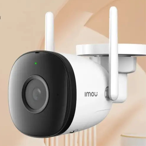 Wireless outdoor security camera with a black lens and white body.