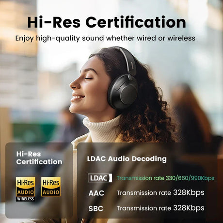 Wireless over-ear headphones worn by a woman with curly hair.