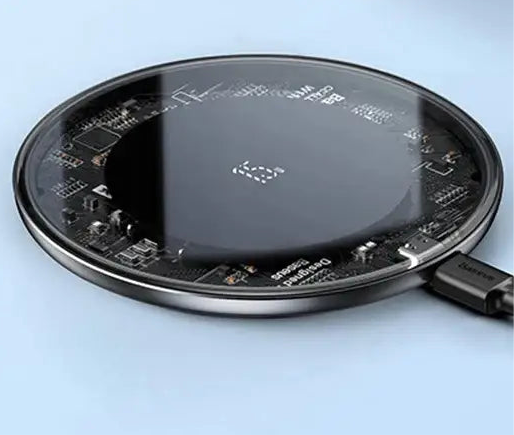 Wireless charging pad with visible internal circuitry.