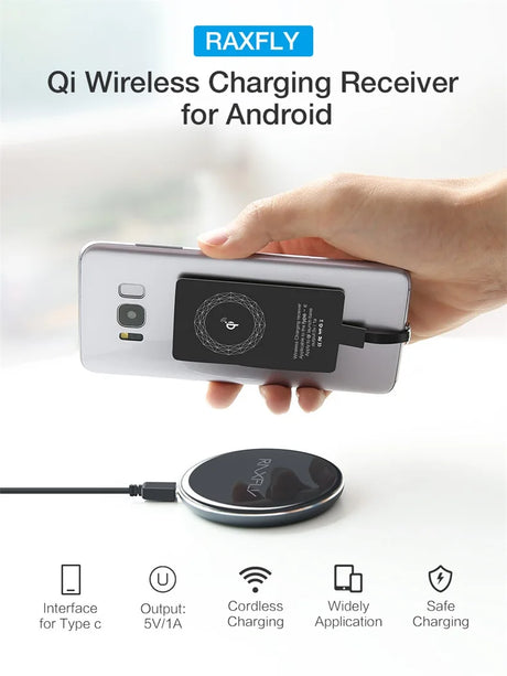 Wireless charging receiver attached to the back of a smartphone.