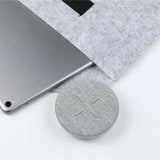 the wireless speaker is placed on top of a laptop
