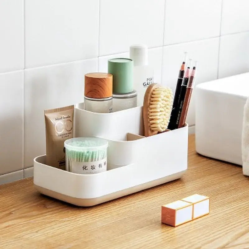 a white bathroom organizer with a cup and toothbrush