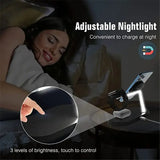 a woman laying in bed with a night light