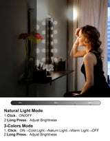 a woman in a black dress looking at herself