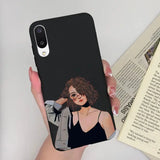 a woman in a black dress holding a phone case