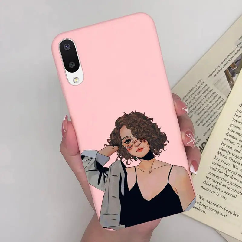 a woman in a black dress holding a pink phone case