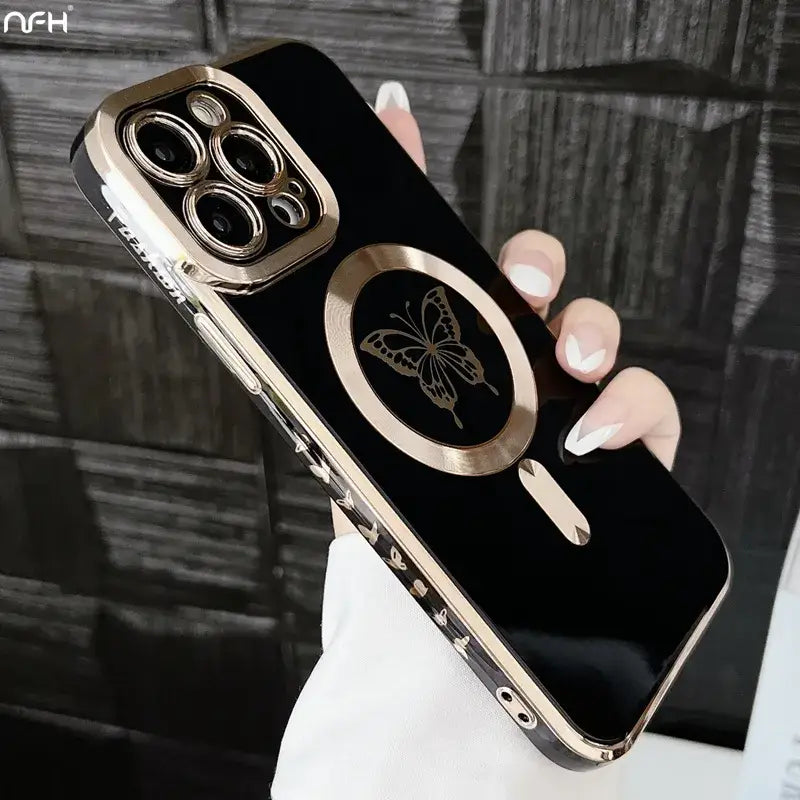 a woman holding a black and gold iphone case