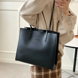 a woman wearing a black handbag