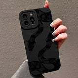 A woman holding a black iphone case