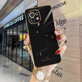 a woman holding up a black iphone case
