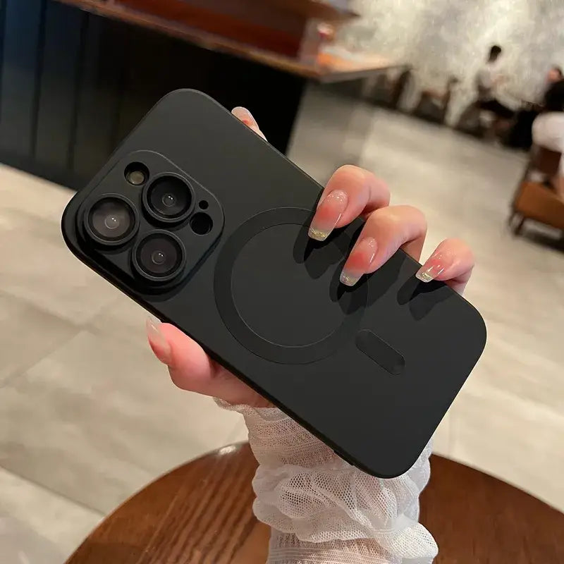a woman holding a black iphone case with a camera lens