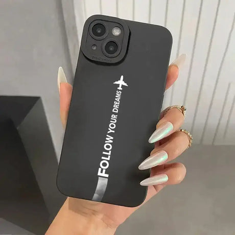 A woman holding a black iphone case with the logo of a fashion brand