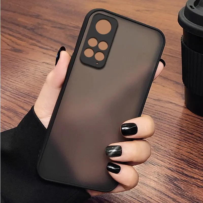 a woman holding a black iphone case