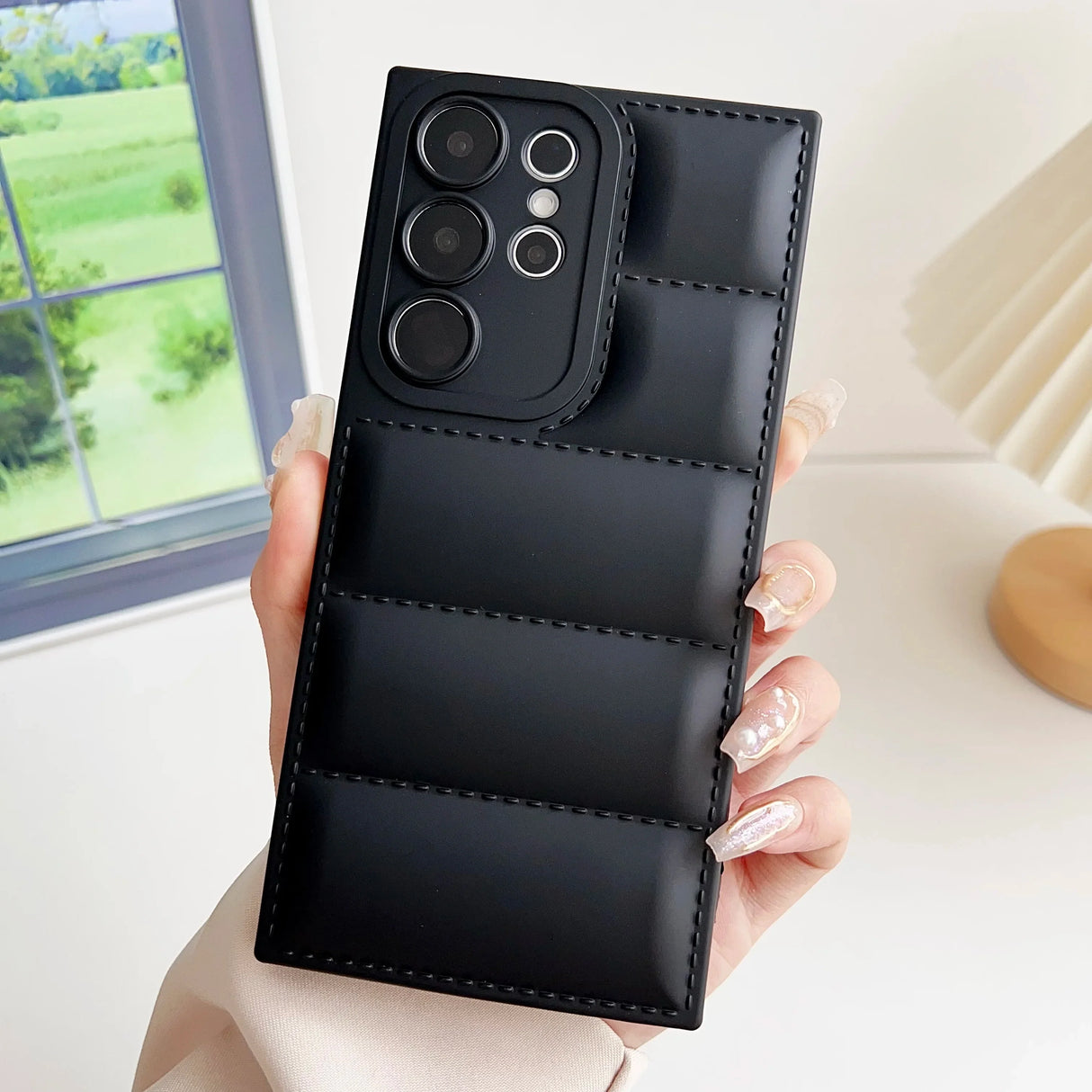 A woman holding a black leather case with two buttons