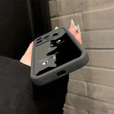 A woman holding a black phone case