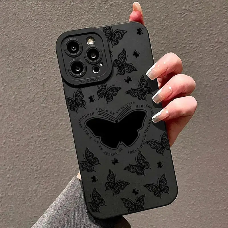 A woman holding a black phone case with a black butterfly design