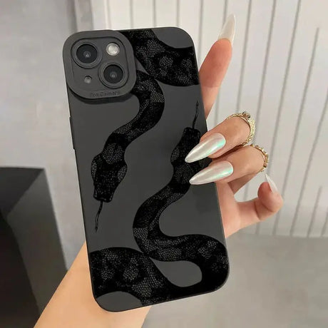 A woman holding a black phone case with a snake on it