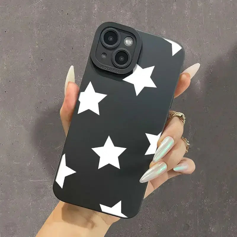 a woman holding a black phone case with white stars on it