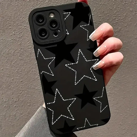 A woman holding a black phone case with stars on it