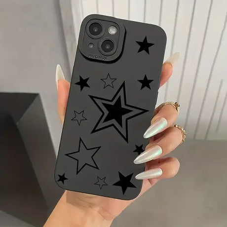 A woman holding a black phone case with stars on it