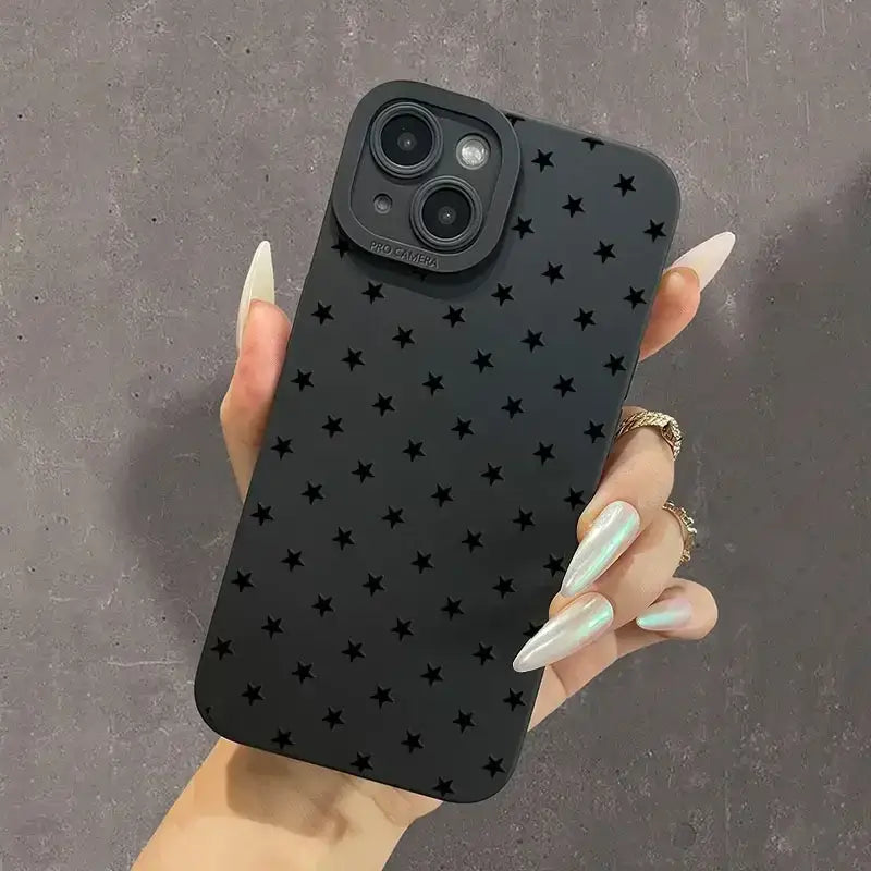 a woman holding a black phone case with stars on it