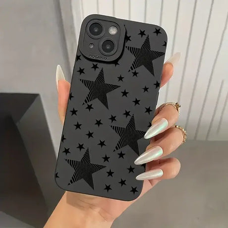 A woman holding a black phone case with stars on it