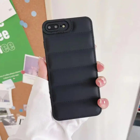 A woman holding a black phone case