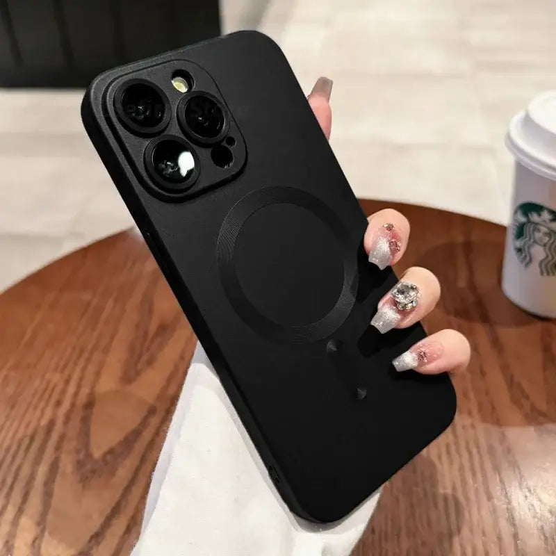 a woman holding a black phone case with a ring on it