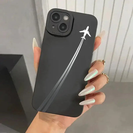 A woman holding a black phone case with a white arrow on it