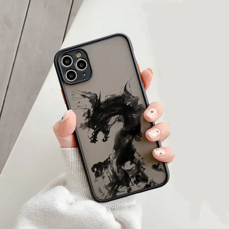 A woman holding a black and white phone case with a horse on it