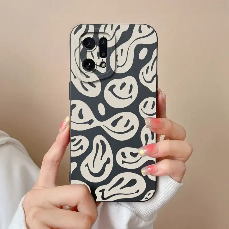 a woman holding up a black and white phone case