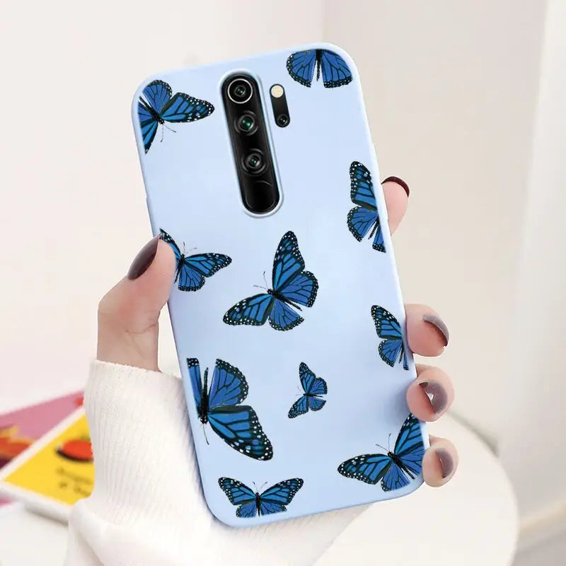 a woman holding a blue butterfly case