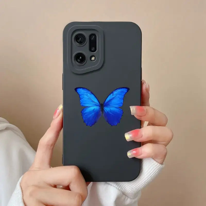 a woman holding a blue butterfly phone case