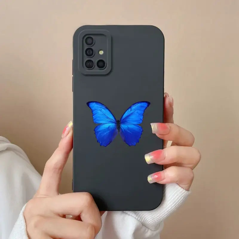 a woman holding a blue butterfly phone case