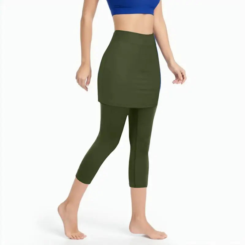 a woman in a blue top and green leggings