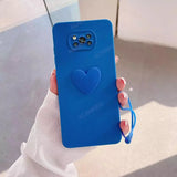 A woman holding a blue heart phone case