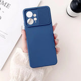 a woman holding a blue iphone case