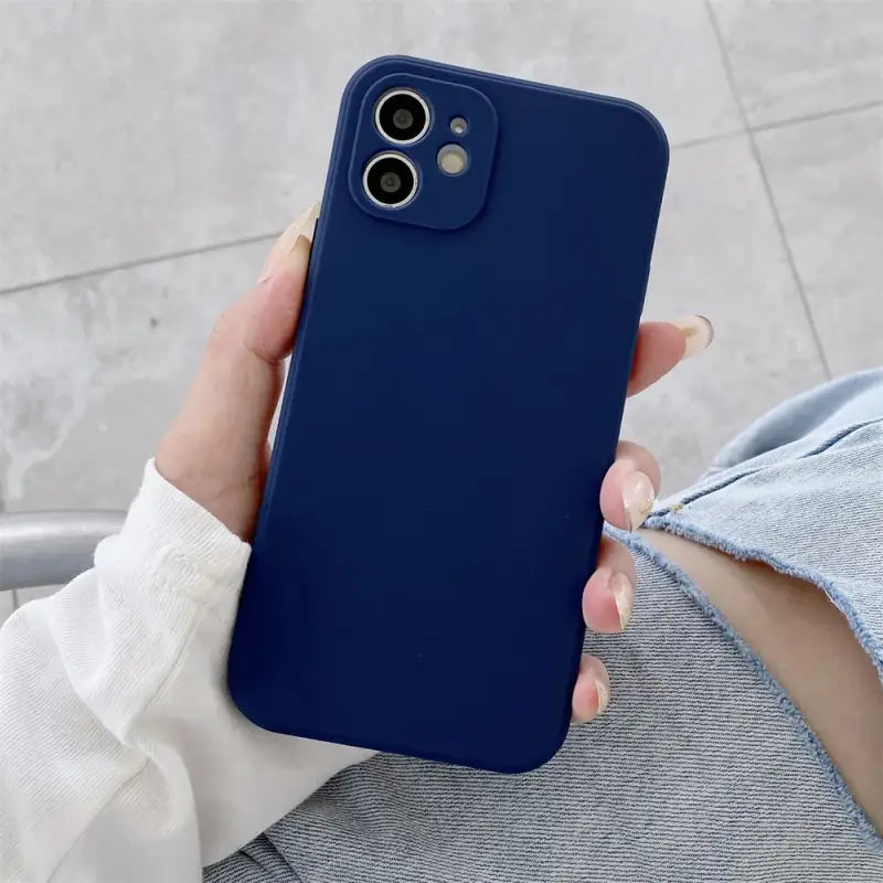 a woman holding a blue iphone case