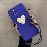 a woman holding a blue phone case with a heart
