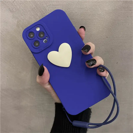 A woman holding a blue phone case with a heart