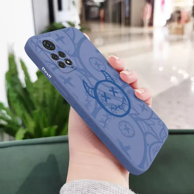 A woman holding a blue phone case with a blue design