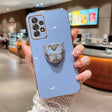 A woman holding a blue phone case with a butterfly on it
